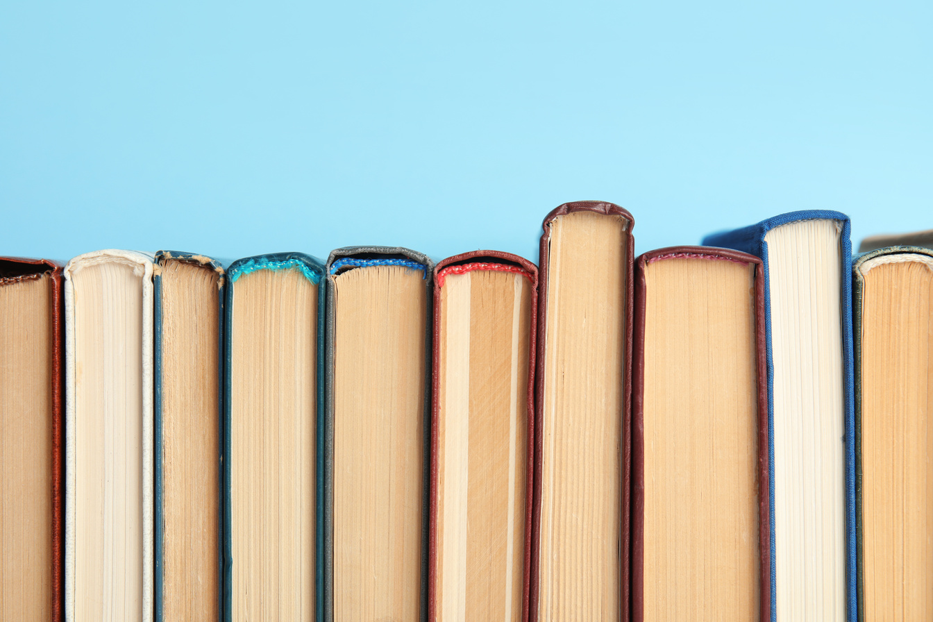 Collection of Old Books on Light Blue Background